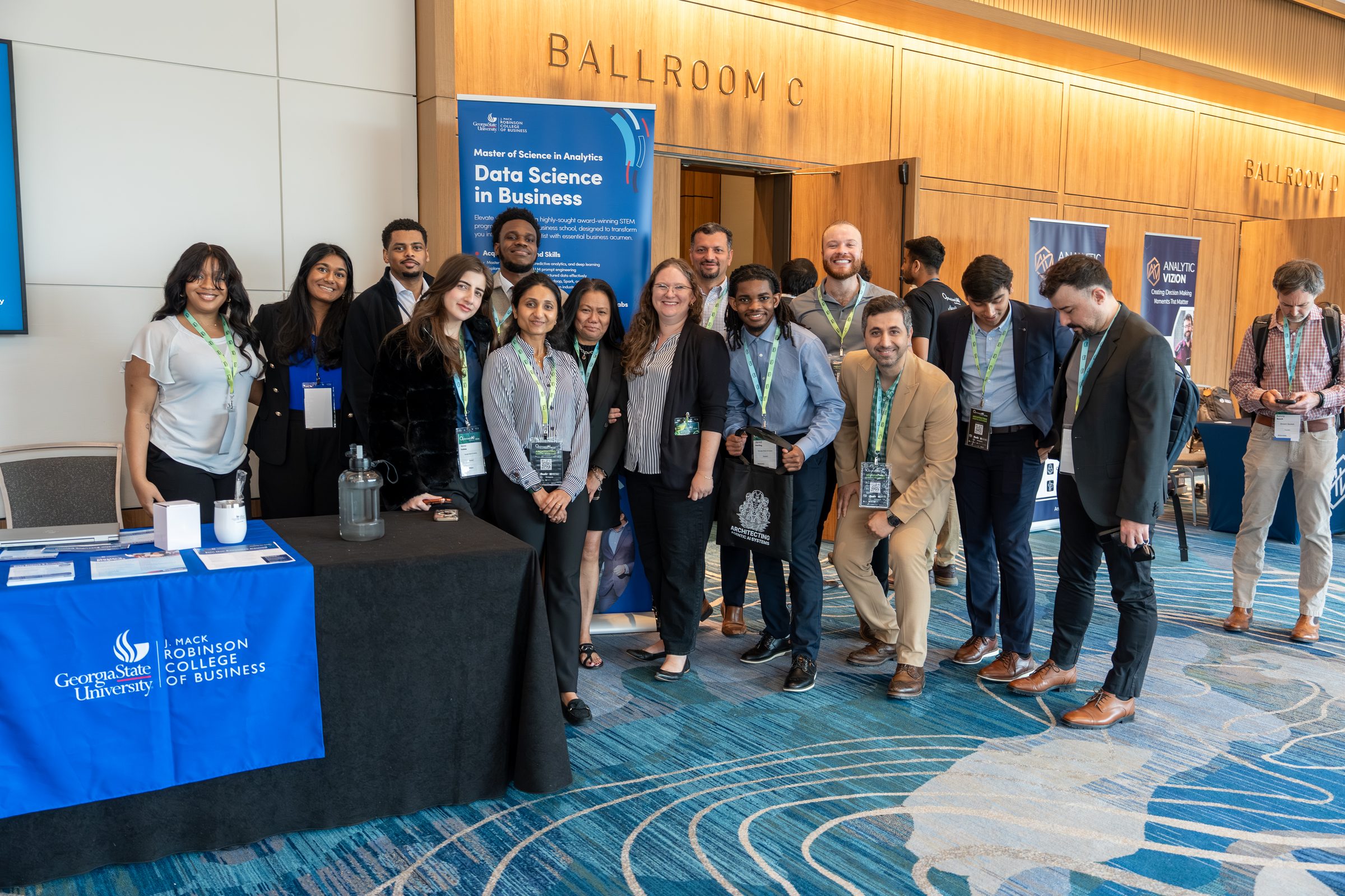 The Georgia State University Robinson College of Business team at their booth outside the Cobb Galleria Centre ballrooms at OAI 2026