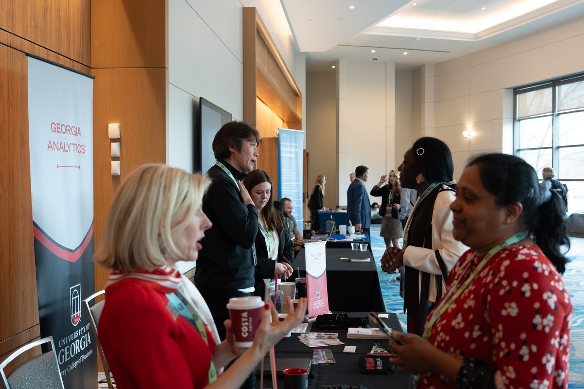 University of Georgia representatives talking with attendees at OAI 2026